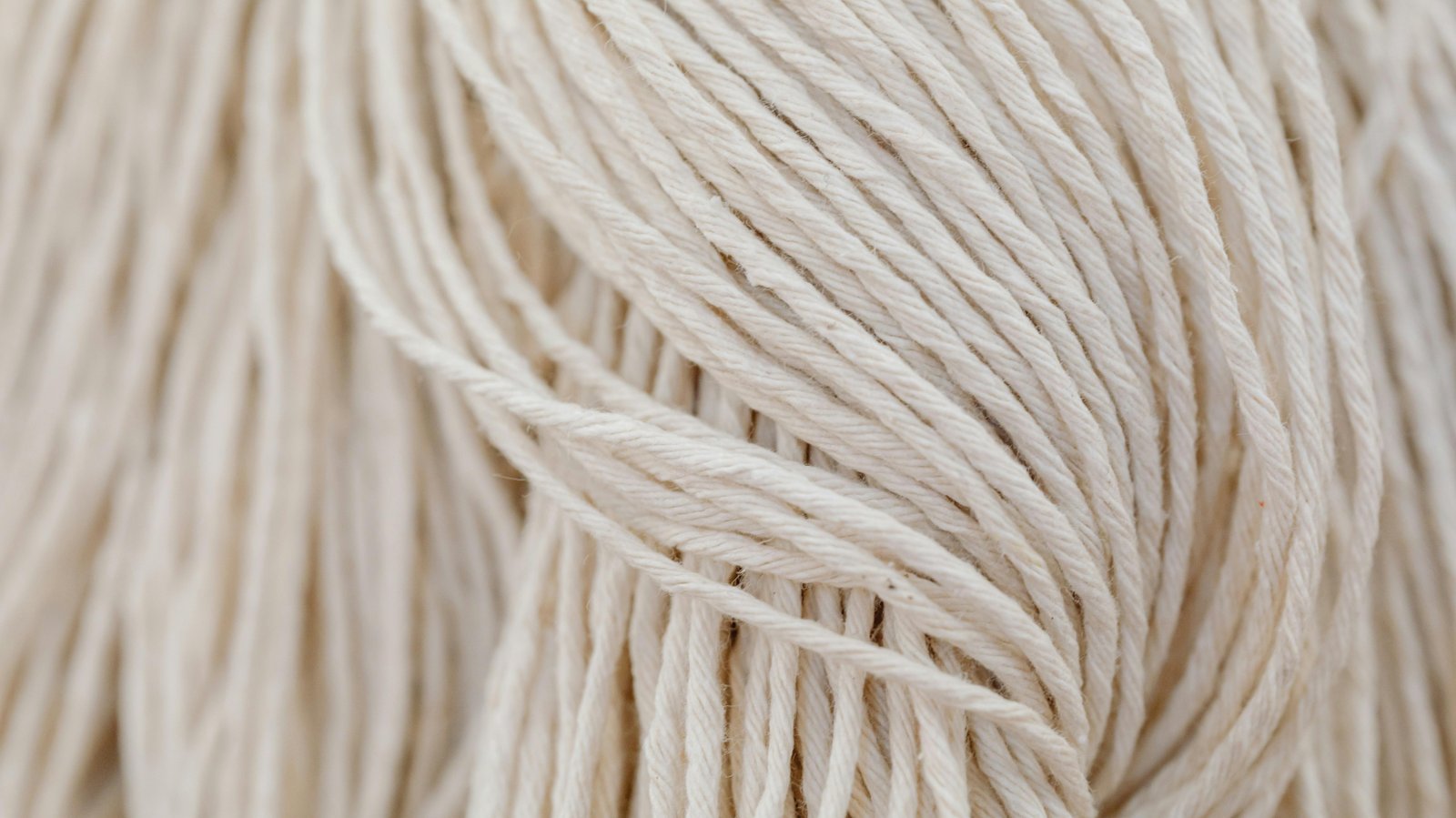 Detailed view of white yarn in a tangled arrangement. Perfect for crafting themes.