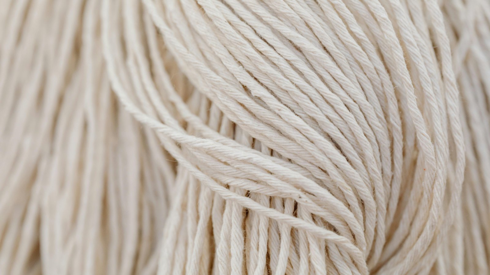 Detailed view of white yarn in a tangled arrangement. Perfect for crafting themes.